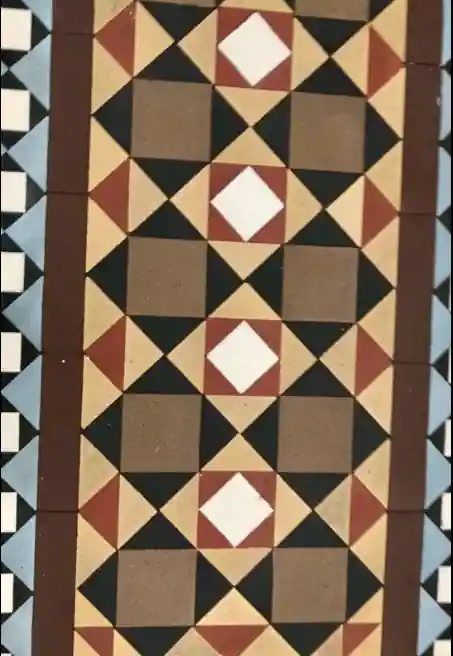A geometric pattern adorns the tiled floor of a Victorian terrace hallway.