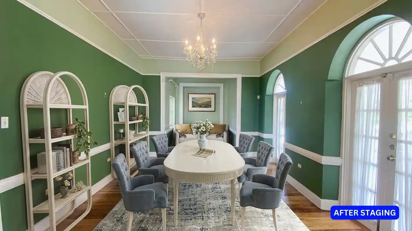A green dining room with a white table and chairs, perfectly staged for sale.