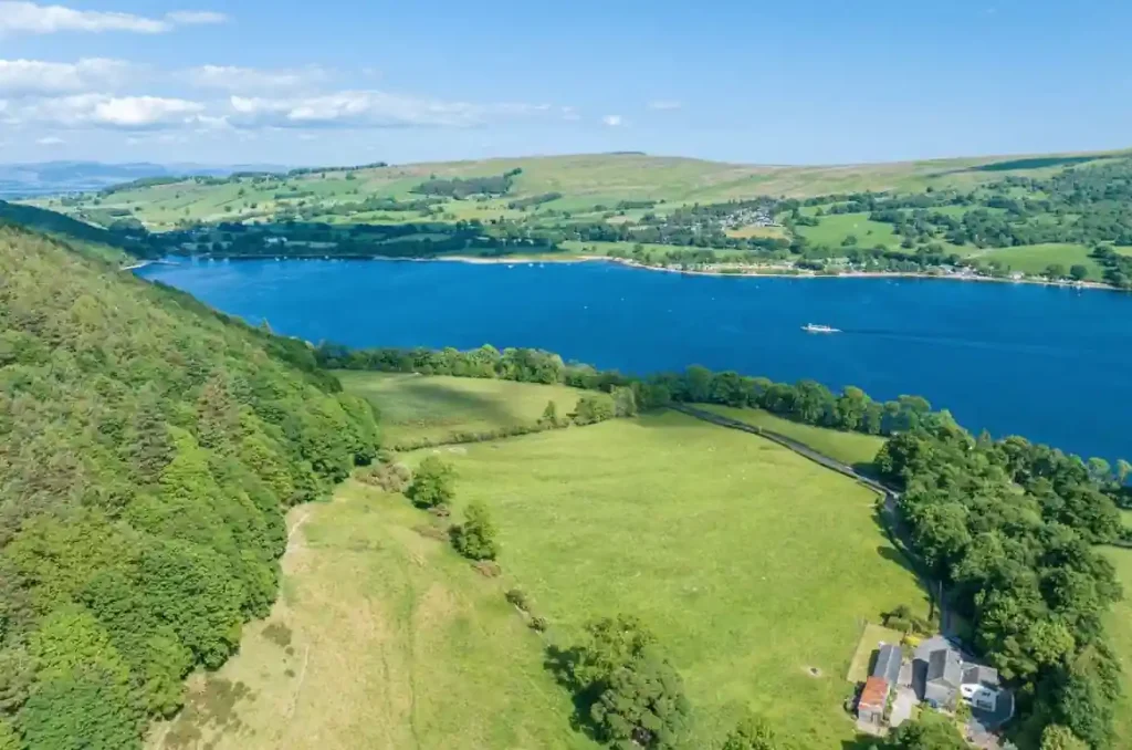 A breathtaking aerial view of the tranquil lake and picturesque countryside in the renowned Belle Grove Estate in Watermillock (bottom right)