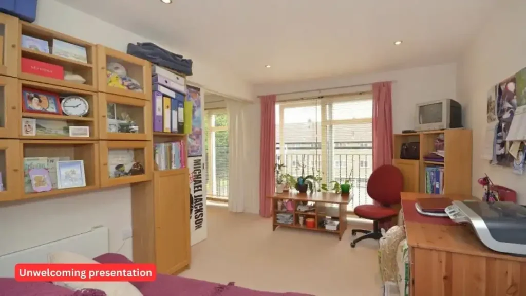 A living room with a desk and bookshelves, tips for the first time landlord becoming.