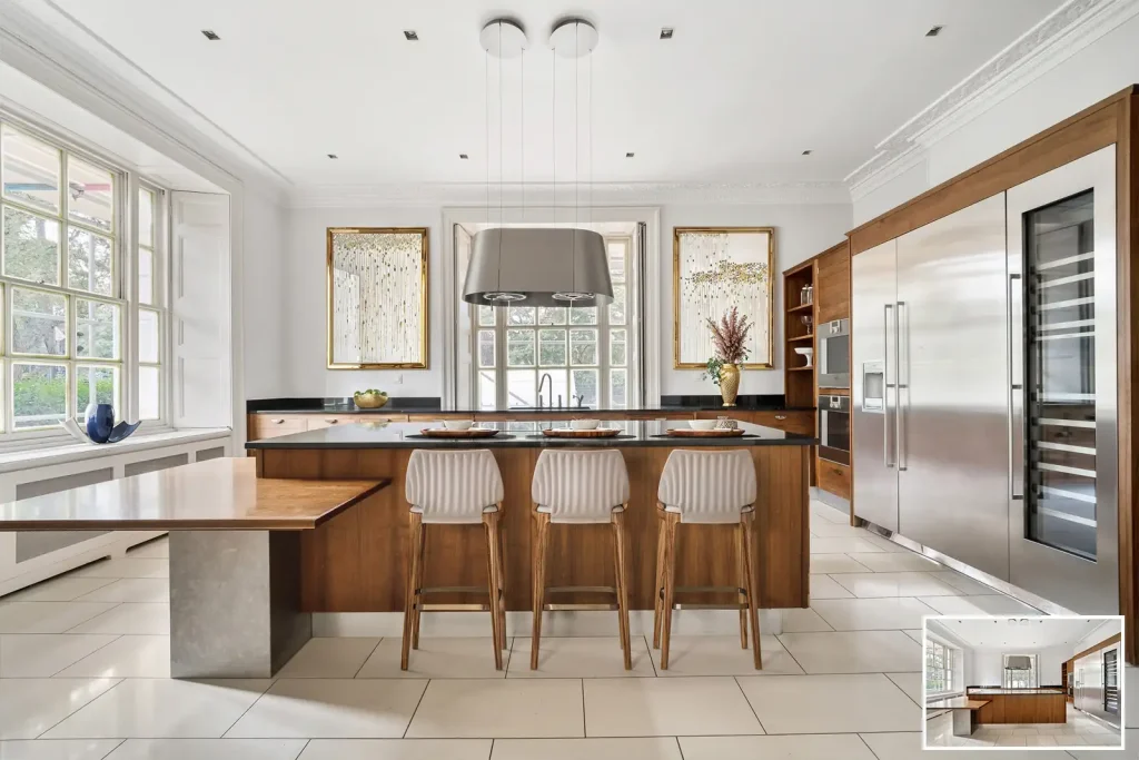 A luxury kitchen with a large island and stools virtually staged by experts.