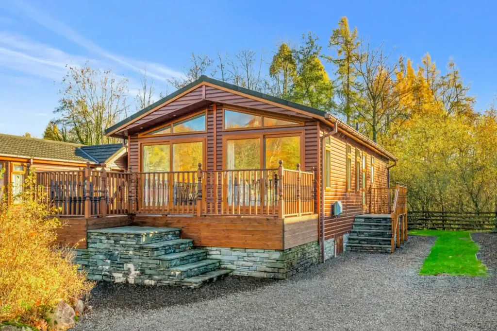 A cozy log cabin nestled in a tranquil wooded area. / Credit: Hackney&Leigh