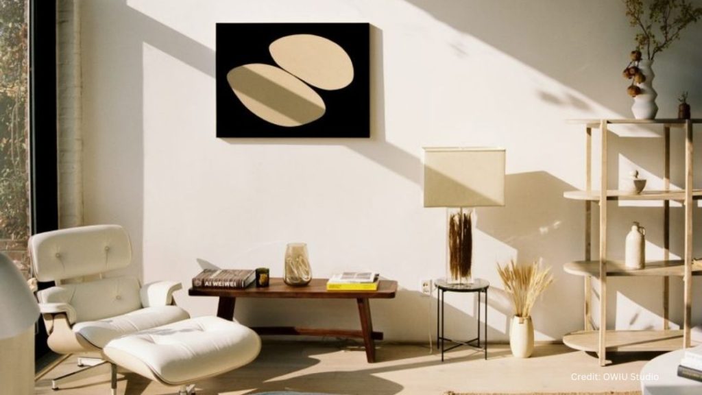 A Japandi Style living room with a black and white painting on the wall.