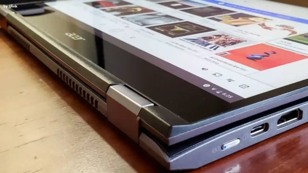 Open Acer Chromebook Spin 714 on a wooden surface displaying a webpage with various multimedia content.
