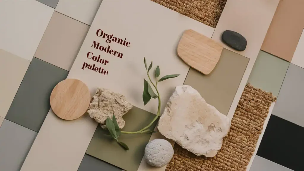A display of an Organic Modern Style color palette with various textures, stones, and wooden elements on a woven mat.