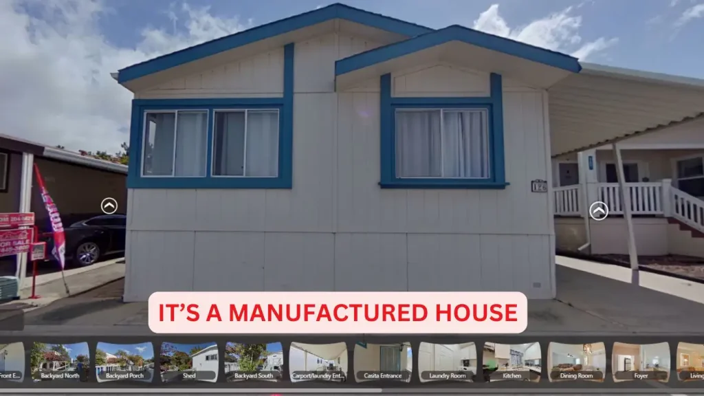 A white manufactured house with blue trim and multiple windows, with text overlay that reads, "IT'S A MANUFACTURED HOME YOU CAN BUY.