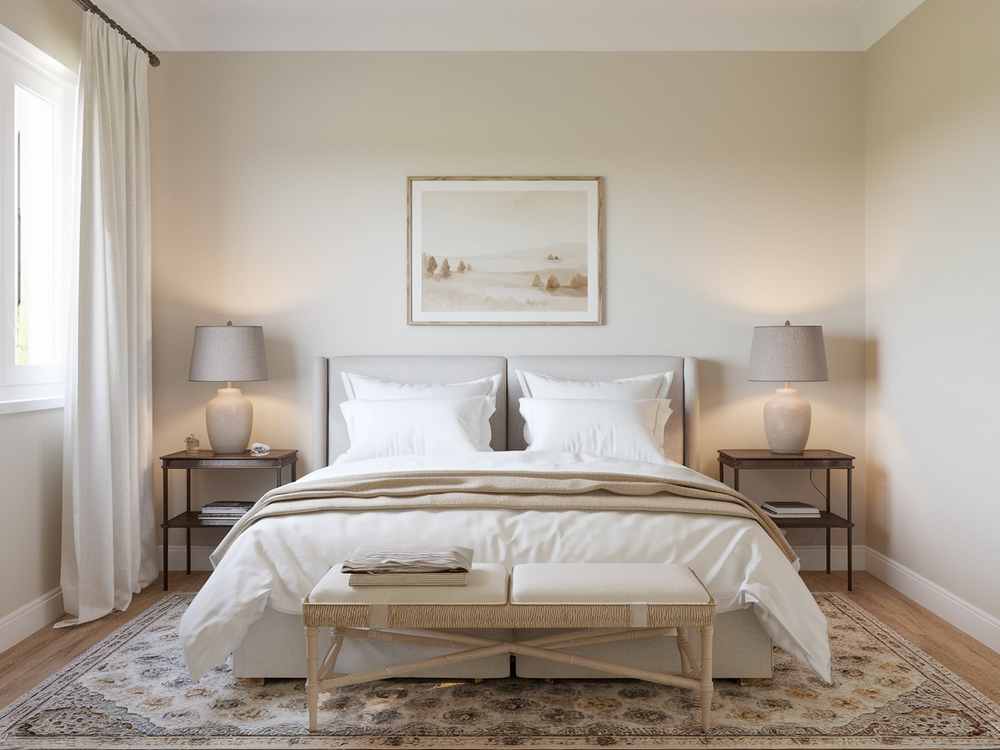 A cozy guest bedroom features a neatly made bed, elegant bedside tables, stylish lamps, and a landscape painting above the headboard, offering the feel of a luxury hotel makeover.