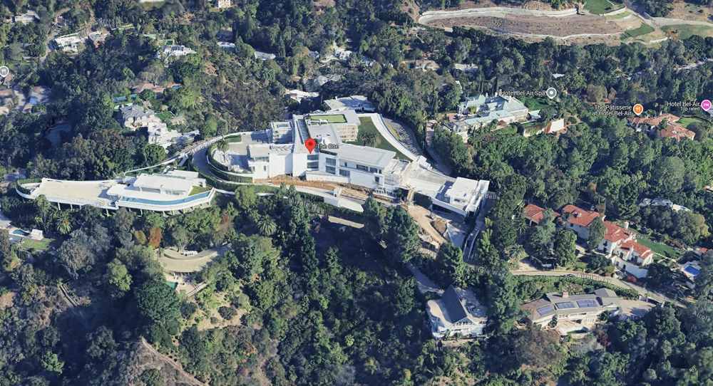 Aerial view of the large modern mansion The One - Bel Air surrounded by trees and nearby houses in a hilly area—perfect inspiration if you’re wondering how big should your house be or need a house sizing guide.