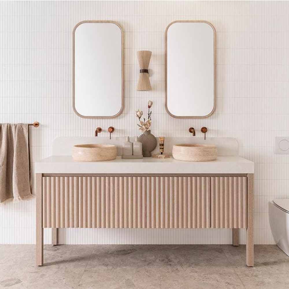 Modern bathroom with double sinks, two mirrors, and neutral-toned decor in a minimalist style features floor-standing vanities that complement the sleek bathroom layout.