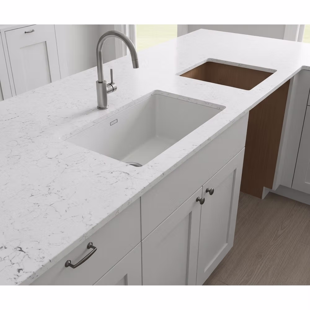 White marble kitchen countertop with a modern sink and faucet, plus white cabinets below—perfect for stage-ready kitchens and a high-ROI remodel to help sell your Boca Raton home.