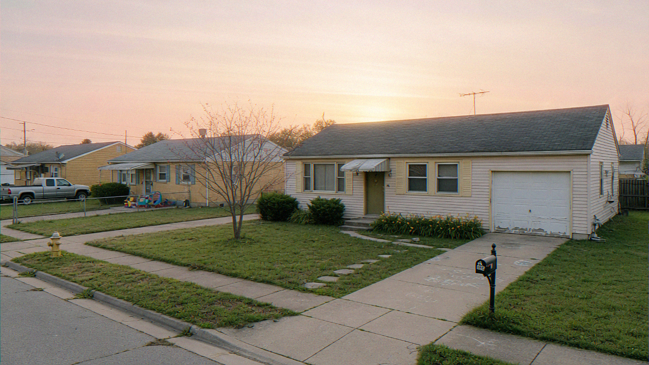 Modest single-story starter home on a quiet street in a lower-priced American neighborhood
